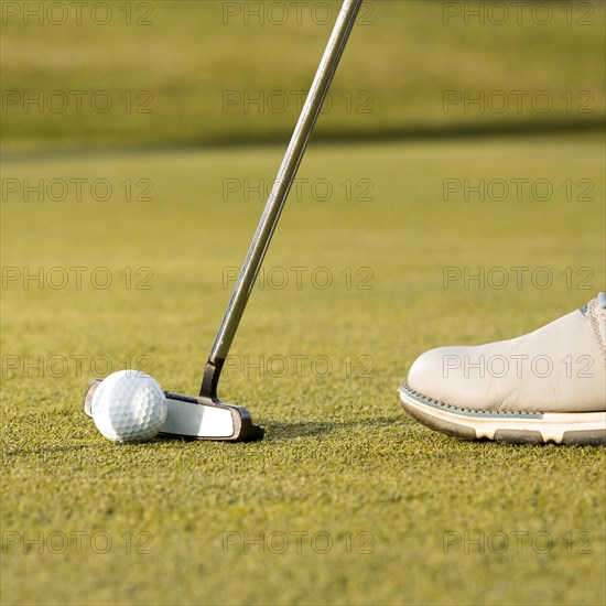 Man using club hit golf ball