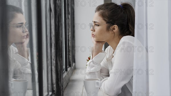 Sideways businesswoman looking outside