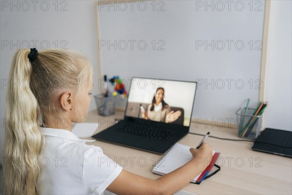 Young girl paying attention online class