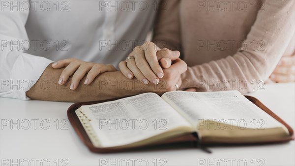 Husband wife reading bible together