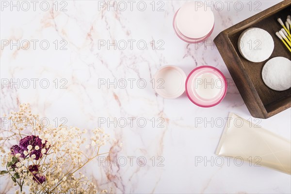 Overhead view moisturizing cream flowers marble