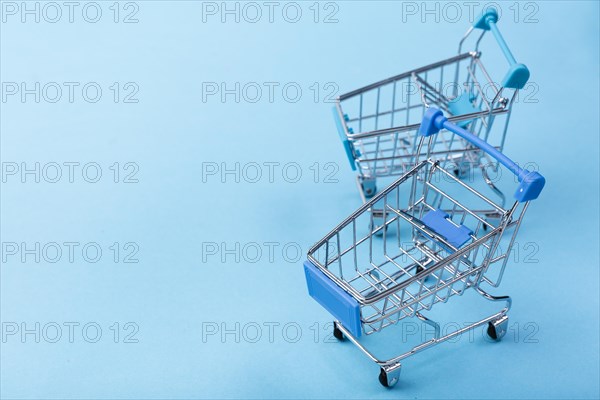 Shopping carts blue background with copy space