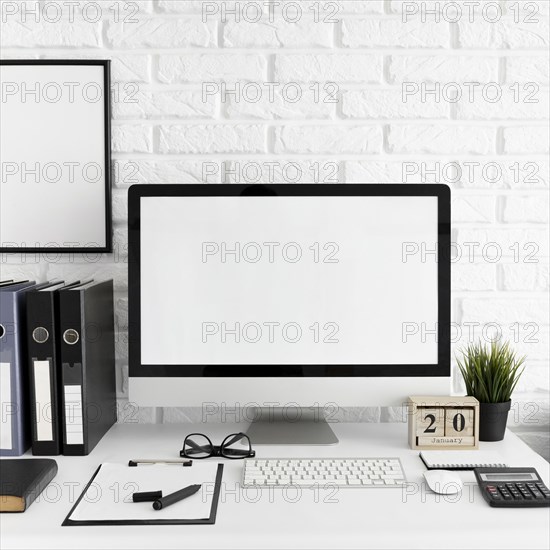 Office desk with computer screen keyboard