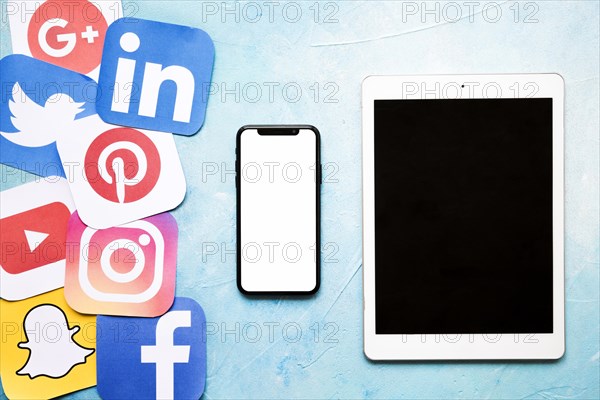 Social media icons with cellphone digital tablet blue painted wall