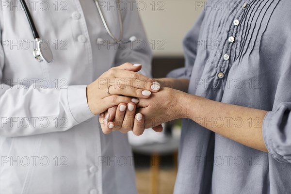 Covid recovery center female doctor holding elder patient s hands