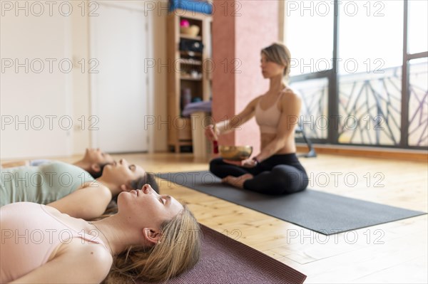 Female yoga teacher teaching class 6