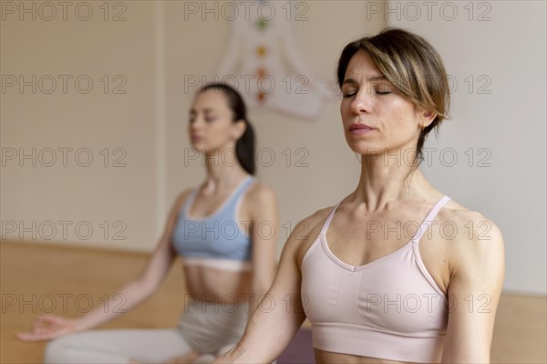 Female yoga teacher teaching class 11