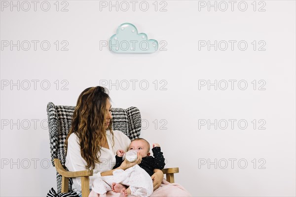 Woman feeding baby cloud