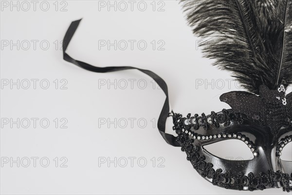 Black carnival mask with feather table