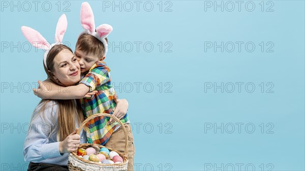 Copy space little boy hugging mom