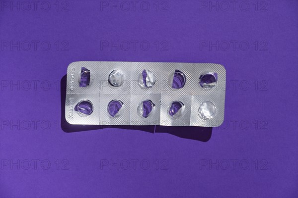 Empty tablet blister pack against a monochrome background