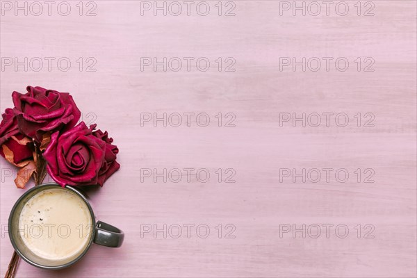 Coffee cup with red roses table