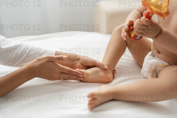 Osteopathist treating baby girl s feet