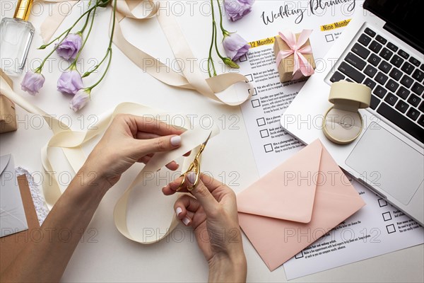 Feminine hands creating handmade invitations