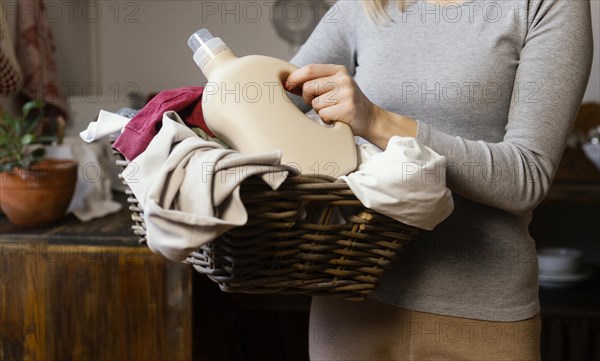 Close up woman holding laundry basket