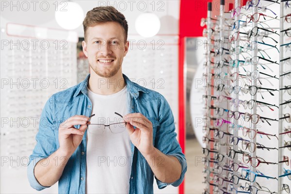 Man looking new glasses optometrist