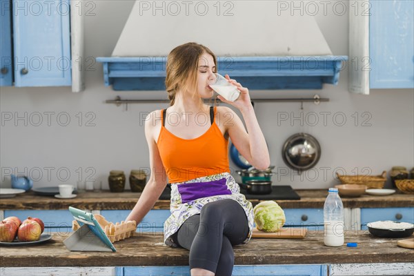 Woman drinking milk counter