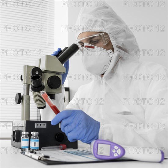 Doctor using microscope check covid sample