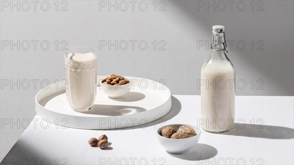 High angle milk bottle with glass tray walnuts