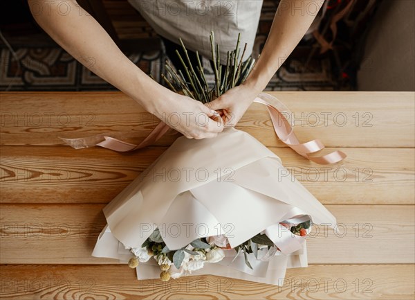 Woman making pretty floral arrangement