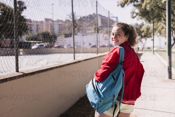 Young girl walking near sportsground