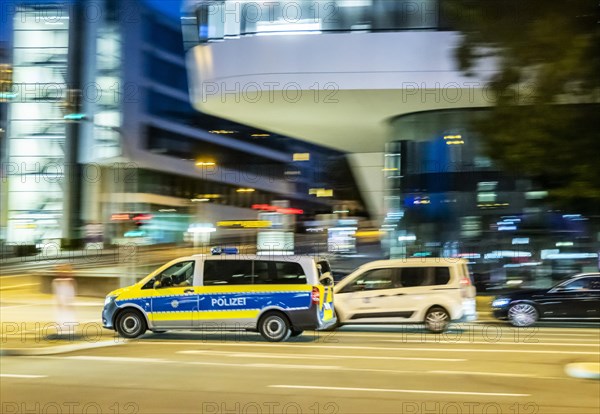 Police vehicle at night in front of urban surroundings