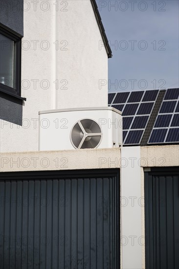 Heat pump on a garage roof of a new development