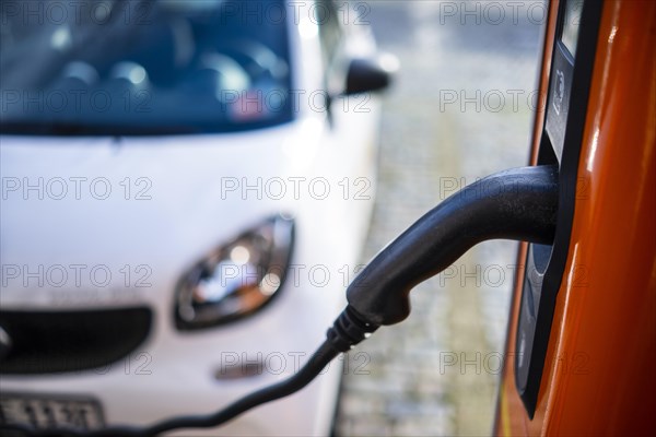 An e-car charges at a public charging station in Aachen