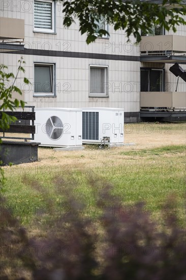 Two heat pumps on a lawn of an apartment building in Duesseldorf