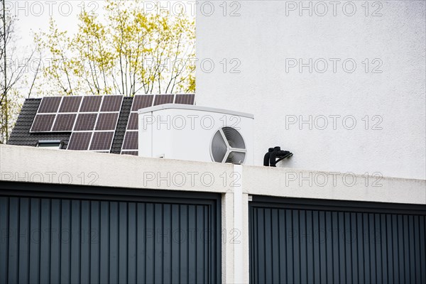 Heat pump on a garage roof of a new development