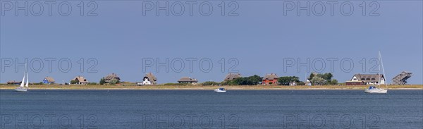 Sailing boats and beach houses along the Baltic Sea on the peninsula Graswarder