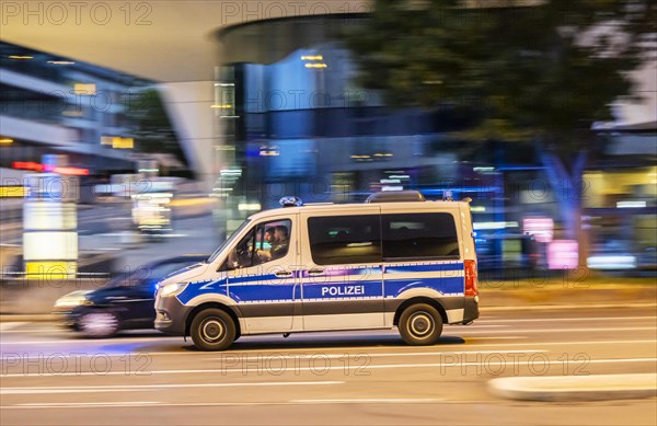 Police vehicle at night in front of urban surroundings