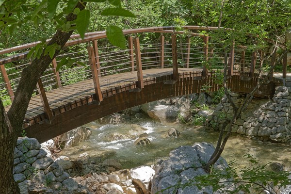 A hiking trail crosses the Paklenica River on a wooden bridge in the Paklenica National Park in northern Dalmatia. Paklenica Starigrad