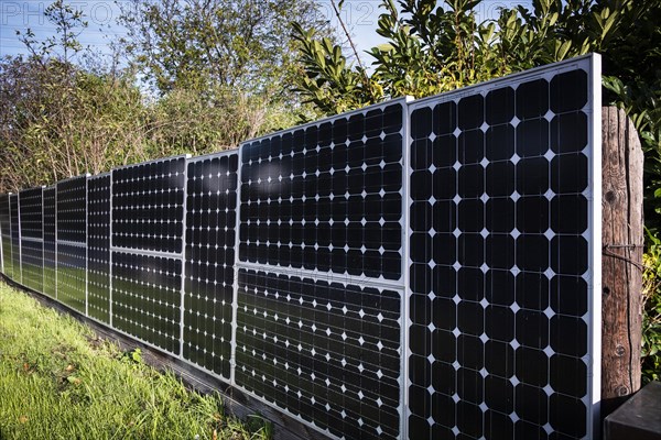 Solar panels as a garden fence and privacy screen of a house on a street in Langenfeld