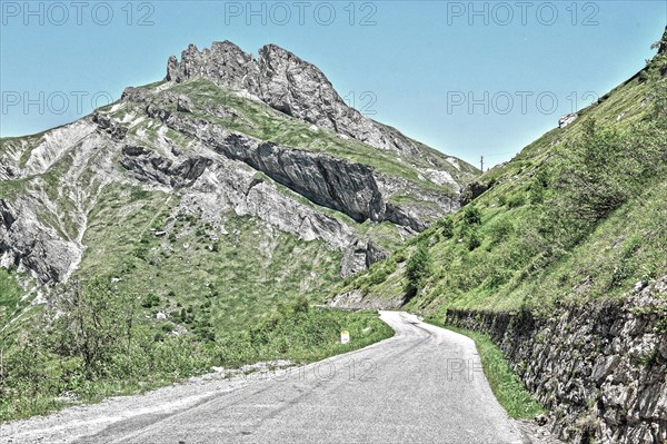 Photo with reduced dynamic range saturation HDR of mountain pass alpine mountain road alpine road pass road pass Cormet de Roselend