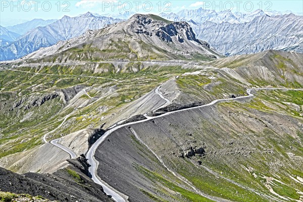 Photo with reduced dynamic saturation HDR of mountain pass alpine mountain road alpine road pass road pass view from viewpoint Cime de la Bonette on Col de la Bonette in French Alps High Alps in high mountains above tree line