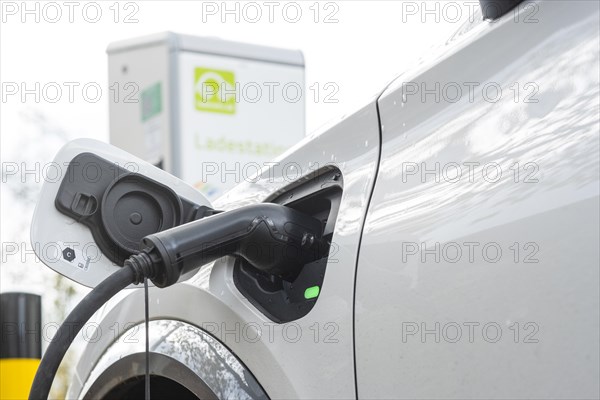 A car being charged at a public charging station