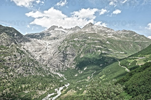 Photo with reduced dynamic saturation HDR of view on in the background Rhone glacier in front river Rotten Rhone right mountain pass alpine mountain road alpine road road pass road pass on Furka Furka pass above above tree line in Swiss Alps High Alps