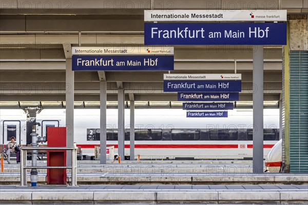 Station sign with platform and ICE of Deutsche Bahn AG