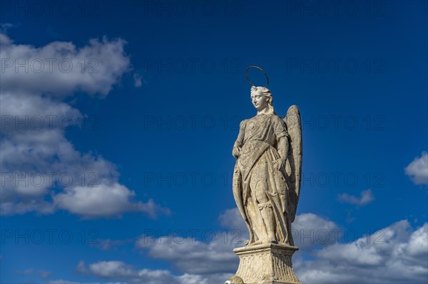 Statue of the Archangel Raphael on the Roman Bridge in Cordoba