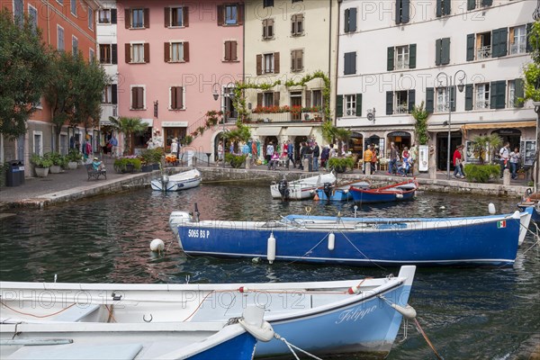 Houses and fishing boats in the old harbour of Limone sul Garda