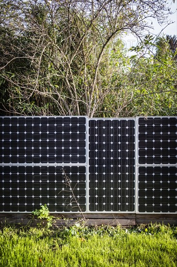 Solar panels as a garden fence and privacy screen of a house on a street in Langenfeld