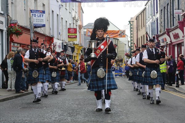 An Irish pipe band marches at the head of the final parade to mark the close of Fleadh Cheoil na hEireann