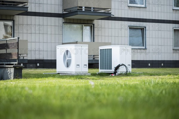 Two heat pumps on a lawn of an apartment building in Duesseldorf