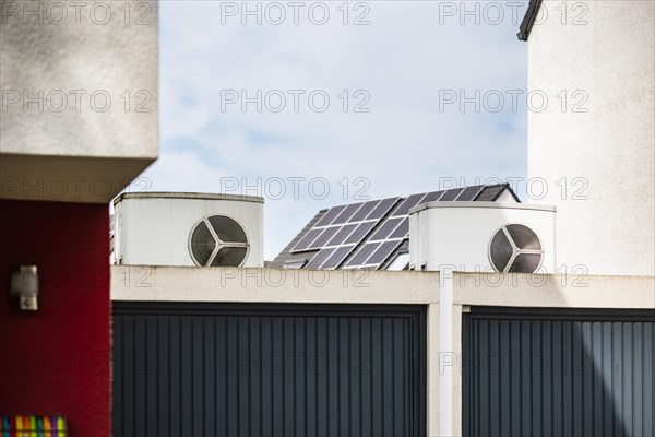 Heat pump on a garage roof of a new development