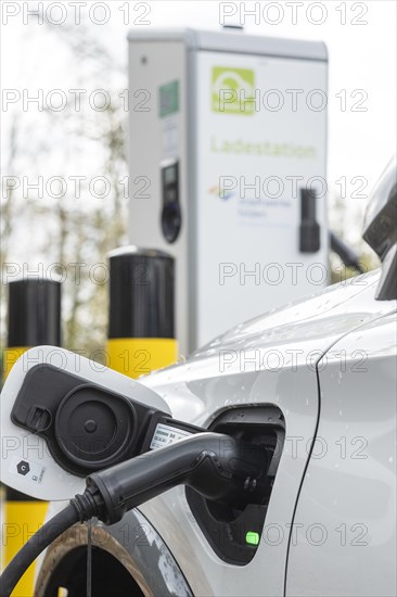A car being charged at a public charging station