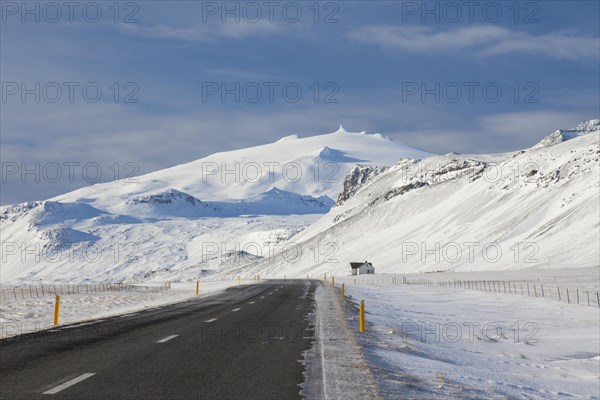 Lonely house along road in desolate landscape in the snow in winter on the Snaefellsnes peninsula in Iceland
