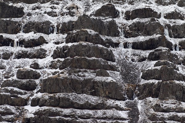 Rock and snow patterns on mountain slope in winter at Snaefellsnes