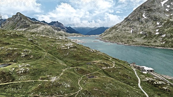 Photo with reduced dynamics saturation HDR of mountain lake at mountain pass alpine mountain road alpine road pass road Bernina Pass Bernina Pass