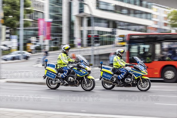 Police motorbike at night in front of urban environment